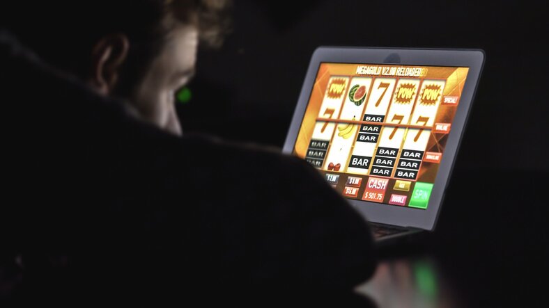 Man Playing Online Slots on his Laptop