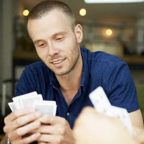 Man Looking at Cards