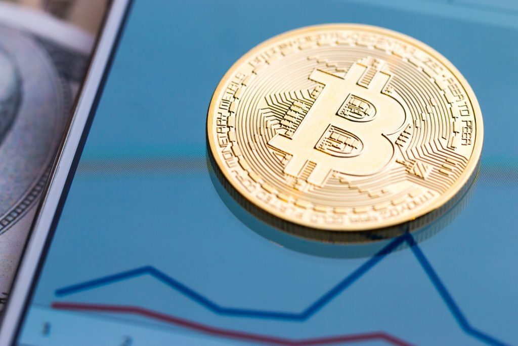 Crypto coin laying on a smartphone for a blog about fast withdrawals at online casinos