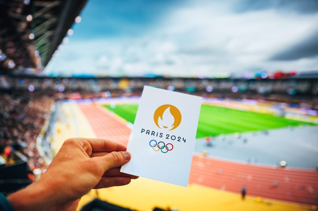 Man holding ticket for track and field event at the Paris 2024 olympics