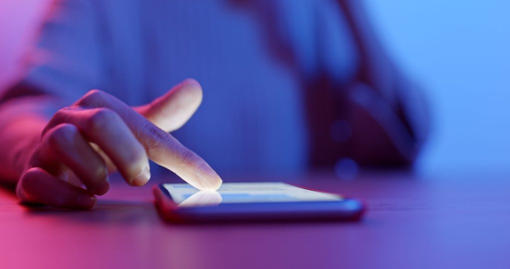 Women using cellphone on table