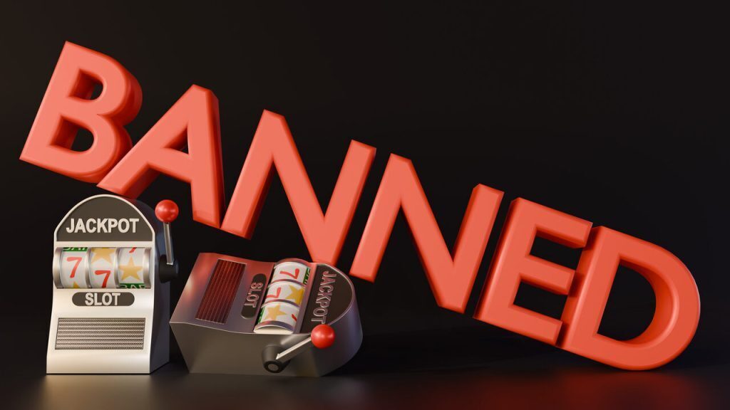 Image of the word BANNED foregrounded by slot machines