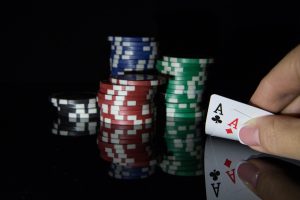 poker-chips-and-cards-in-hand